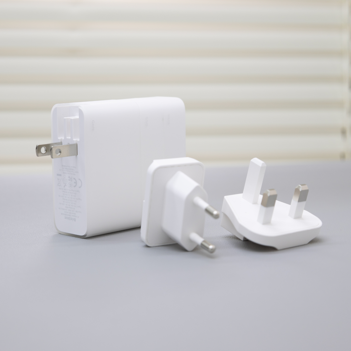 BricBloc charger with US, EU, and UK plug adapters.